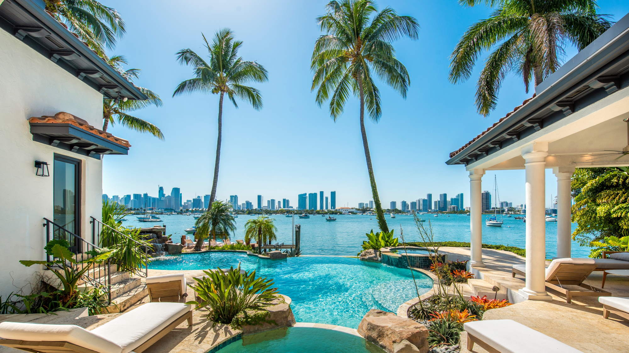Couple sitting together on couch looking at laptop